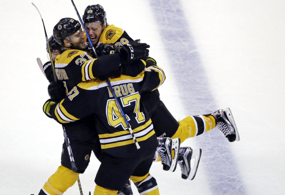 FILE - Boston Bruins center Patrice Bergeron (37) celebrates his goal with teammates right wing David Pastrnak (88) and defenseman Torey Krug (47) in the third period of an NHL hockey game, Thursday, Oct. 20, 2016, in Boston. Bruins forward Patrice Bergeron has retired. The five-time Selke Trophy winner announced Tuesday, July 25, 2023, that he will not return for a 20th season with the only team he has ever played for. The Bruins captain said he is leaving with no regrets.(AP Photo/Elise Amendola, File)