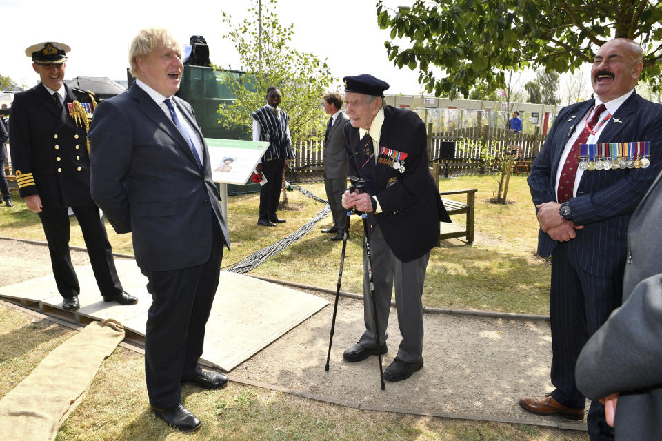Britain's Prime Minister Boris Johnson meets with veteran Bill Redston following the national service of remembrance marking the 75th anniversary of V-J Day at the National Memorial Arboretum in Alrewas, England, Saturday Aug. 15, 2020. Following the surrender of the Nazis on May 8, 1945, V-E Day, Allied troops carried on fighting the Japanese until an armistice was declared on Aug. 15, 1945. (Anthony Devlin/PA via AP)