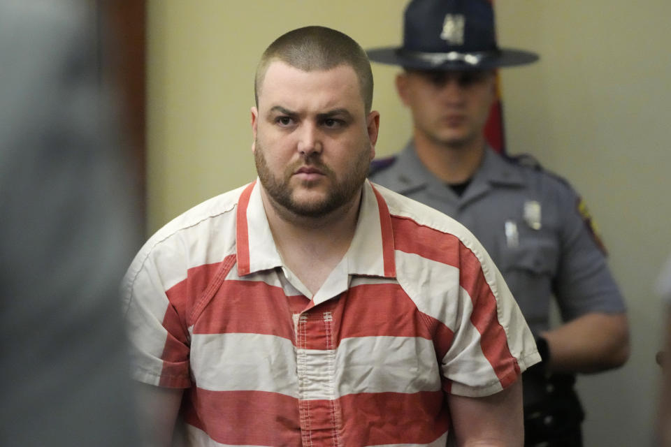 Christian Dedmon, a former Rankin County Sheriff's Deputy and one of six former Mississippi law enforcement officers who pleaded guilty to a long list of state and federal charges, enters the Rankin County Circuit Court to listen to the victims' impact statements, prior to the state sentencing for his involvement in the 2023 racially motivated torture of two Black men, Wednesday, April 10, 2024, in Brandon, Miss. The judge gave the six former Mississippi law enforcement officers yearslong state sentences that were shorter than the amount of time in federal prison that they'd already received. (AP Photo/Rogelio V. Solis)