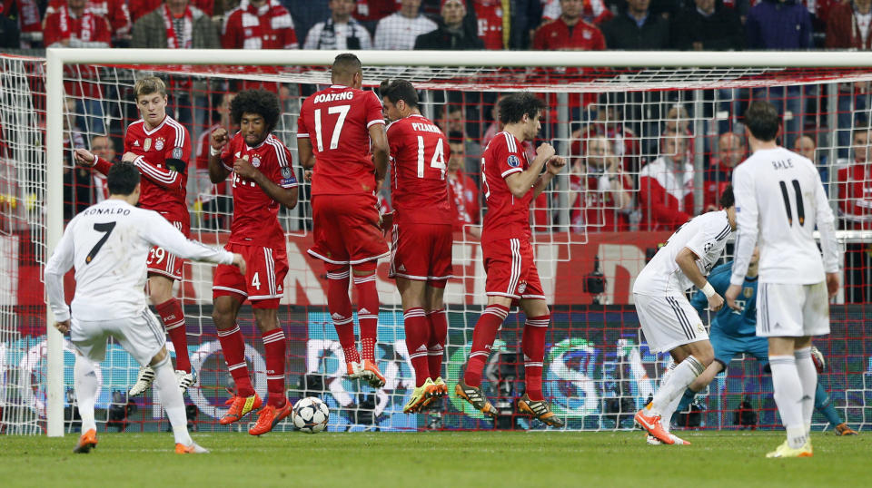 Real's Cristiano Ronaldo scores his side's 4th goal after a free kick during the Champions League semifinal second leg soccer match between Bayern Munich and Real Madrid at the Allianz Arena in Munich, southern Germany, Tuesday, April 29, 2014. (AP Photo/Matthias Schrader)