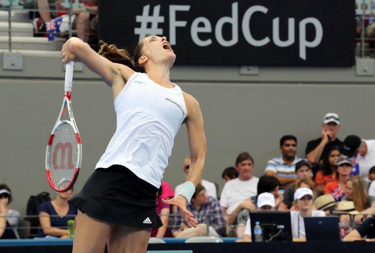 Germany's Andrea Petkovic serves against Australia's Sam Stosur in their women's singles tennis match during the Fed Cup semi-final tie in Brisbane on April 19, 2014