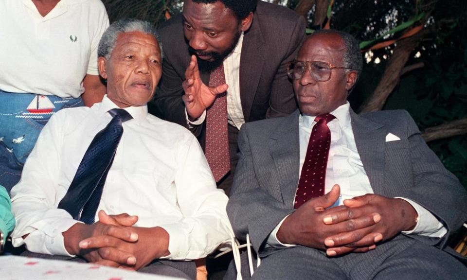 Nelson Mandela and Andrew Mlangeni listening to a young Cyril Ramaphosa in 1990