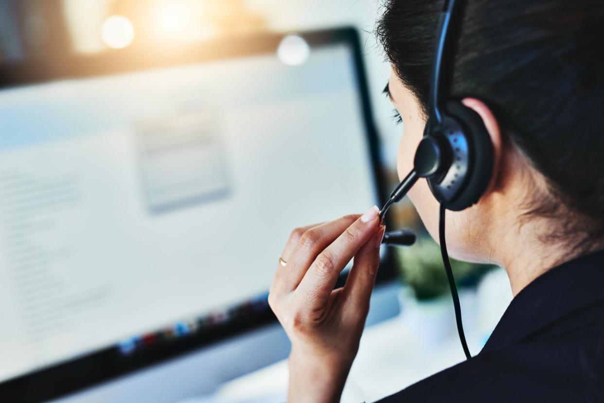 Rearview shot of a young woman working in a call centre