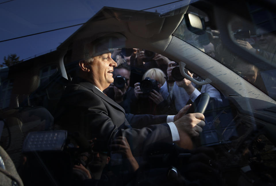 FILE - In this Sunday, April 8, 2018 file photo, Hungary's prime minister Viktor Orban sits in a car outside a polling station in Budapest, Hungary. When Hungary and Poland joined the European Union in 2004, after decades of Communist domination, they thirsted for Western democratic standards and prosperity yet, 17 years later, as the EU ramps up efforts to rein in democratic backsliding in both countries, some of the governing right-wing populists in Hungary and Poland are comparing the bloc to their former Soviet oppressors — and flirting with the prospect of exiting the bloc. (AP Photo/Darko Vojinovic, FIle)