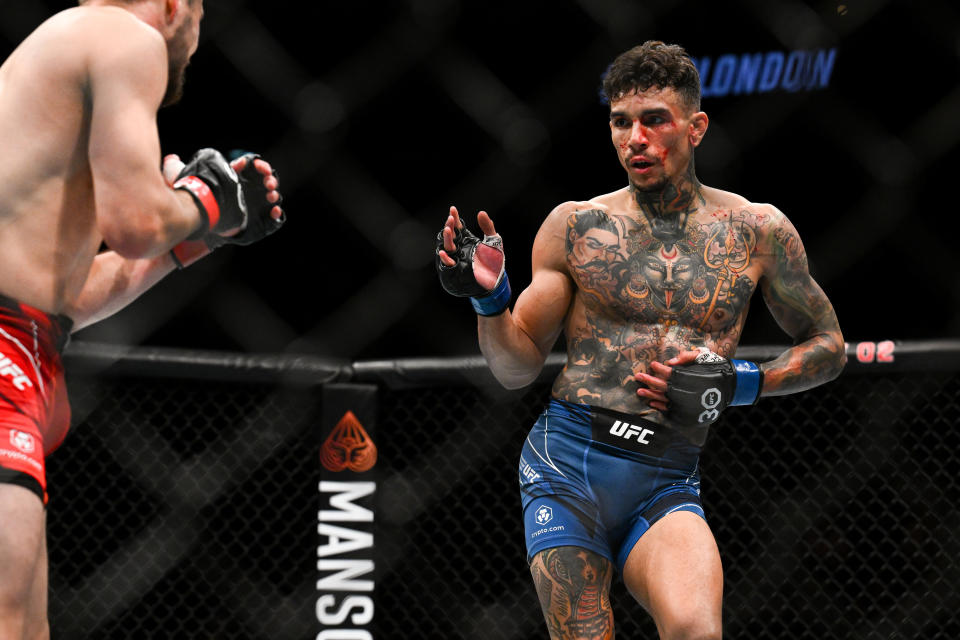 Jul 22, 2023; London, UNITED KINGDOM; Nathaniel Wood (red gloves) fights Andre Fili (blue gloves) during UFC Fight Night at O2 Arena. Mandatory Credit: Per Haljestam-USA TODAY Sports