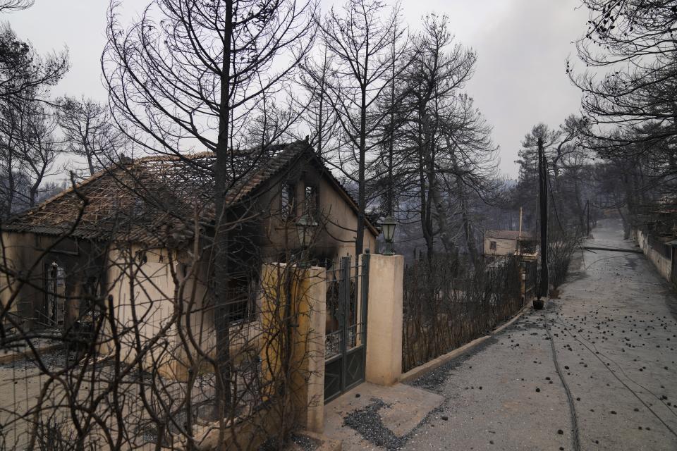 A burnt house after a wildfire in Drosopigi village, about 28 kilometres (27 miles) north of Athens, Greece, Friday, Aug. 6, 2021. Thousands of residents of the Greek capital have fled to safety from a wildfire that burned for a fourth day north of Athens as crews battle to stop the flames reaching populated areas, electricity installations and historic sites. (AP Photo/Thanassis Stavrakis)