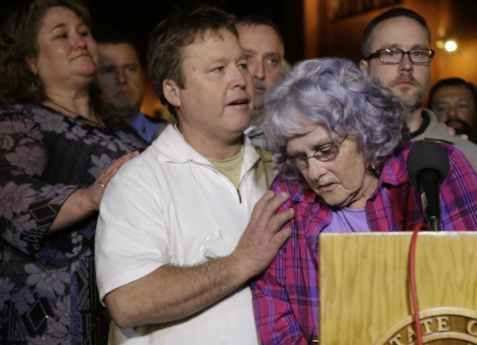 Gayle Gaddis, mother of slain Houston police officer Guy Gaddis, is helped by her son Edwin after addressing the outside the prison walls after the execution of Mexican national Edgar Tamayo Wednesday, Jan. 22, 2014, in Huntsville, Texas. Tamayo was convicted of killing Gaddis 20 years ago. The Gaddis family were witnesses to the execution. (AP Photo/Pat Sullivan)