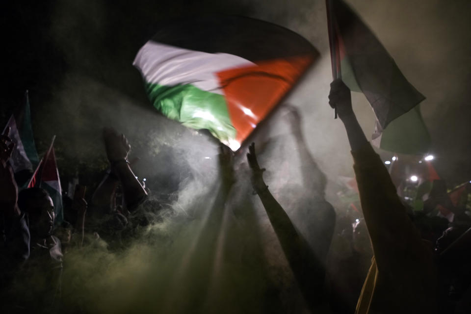 People chant anti-Israel slogans while waving Palestinian flags during a rally celebrating the attacks that the militant Hamas group carried out against Israel, in Istanbul, Turkey, Saturday, Oct. 7, 2023. (AP Photo/Khalil Hamra)