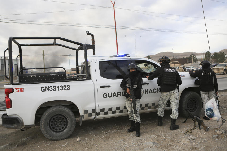 Mexican National Guard stand guard outside a state prison in Ciudad Juarez, Mexico, Sunday Jan 1, 2023. Mexican soldiers and state police regained control of a state prison in Ciudad Juarez across the border from El Paso, Texas after violence broke out early Sunday, according to state officials. (AP Photo/Christian Chavez)