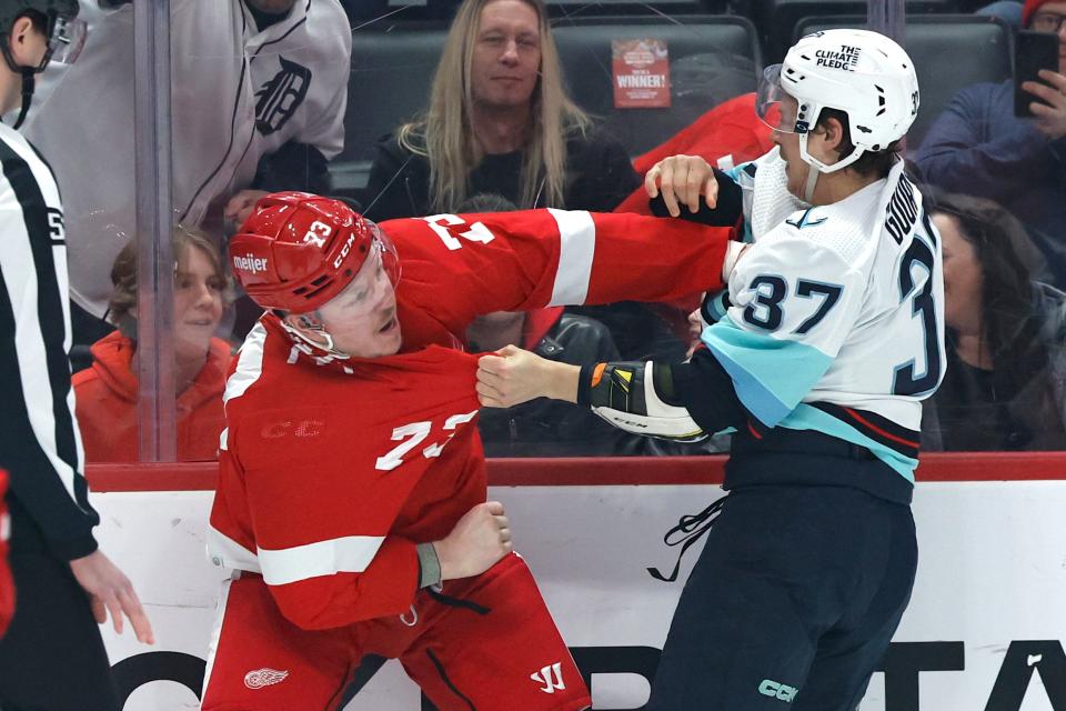 Detroit Red Wings forward Adam Erne (73) and Seattle Kraken center Yanni Gourde (37) fight in the first period at Little Caesars Arena in Detroit on Thursday, March 2, 2023.
