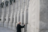 President Joe Biden and first lady Jill Biden visit the National World War II Memorial to mark the 80th anniversary of the Japanese attack on Pearl Harbor, Tuesday, Dec. 7, 2021, in Washington. (AP Photo/Evan Vucci)