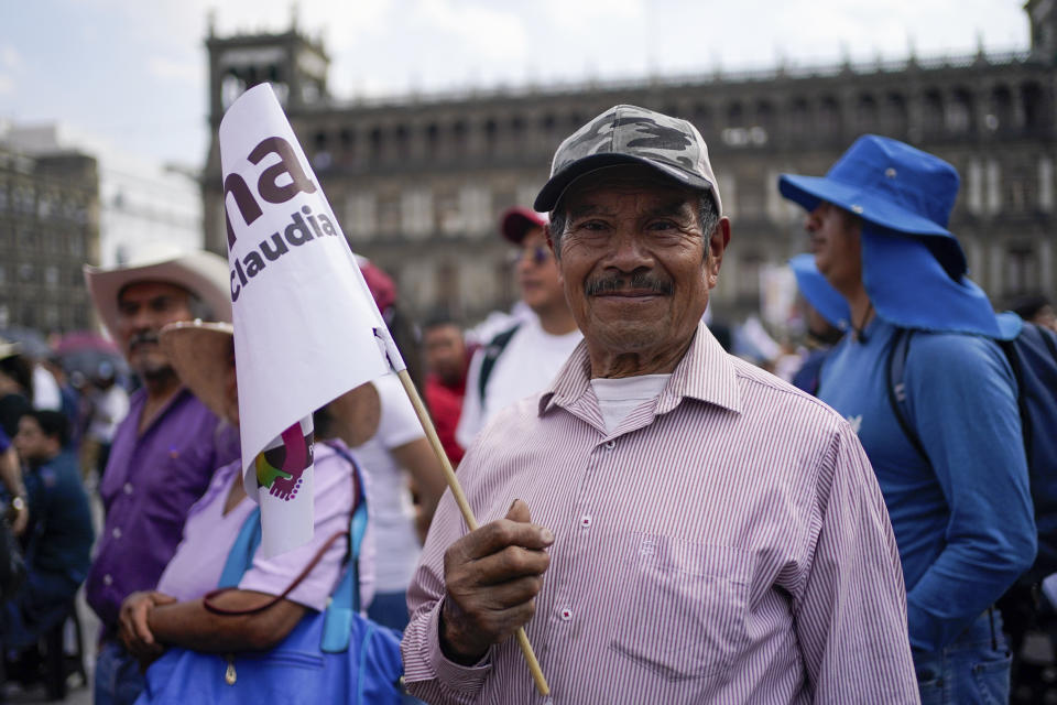 A supporter of ruling party presidential candidate Claudia Sheinbaum attends her opening campaign rally at the Zocalo in Mexico City, March 1, 2024. Mexican voters will go to the polls in the largest elections in the country’s history on June 2, 2024. In the presidential race, they will have to choose between three candidates, but two women have taken the lead: Sheinbaum and opposition candidate Xóchitl Gálvez. (AP Photo/Aurea Del Rosario, File)