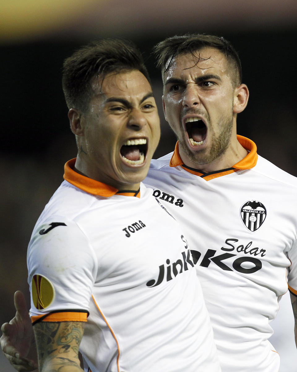 Valencia’s Paco Alcacer, right, celebrates with Eduardo Vargas from Chile after scoring against Basel during the Europa League quarterfinal, second leg soccer match at the Mestalla stadium in Valencia, Spain, on Thursday, April 10, 2014. Valencia lost 3-0 in the first leg at Basel. (AP Photo/Alberto Saiz)