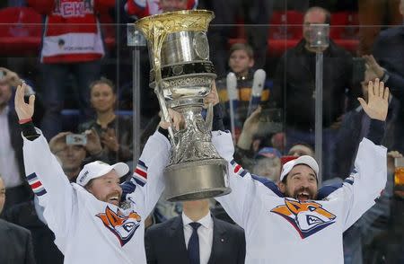 Ice Hockey - CSKA Moscow v Metallurg Magnitogorsk - Kontinental Hockey League - Gagarin Cup Grand Final, awarding ceremony - Moscow, Russia - 19/04/16 Metallurg Magnitogorsk's Sergei Mozyakin and Danis Zaripov lift the trophy as they celebrate winning the Gagarin Cup. REUTERS/Maxim Shemetov