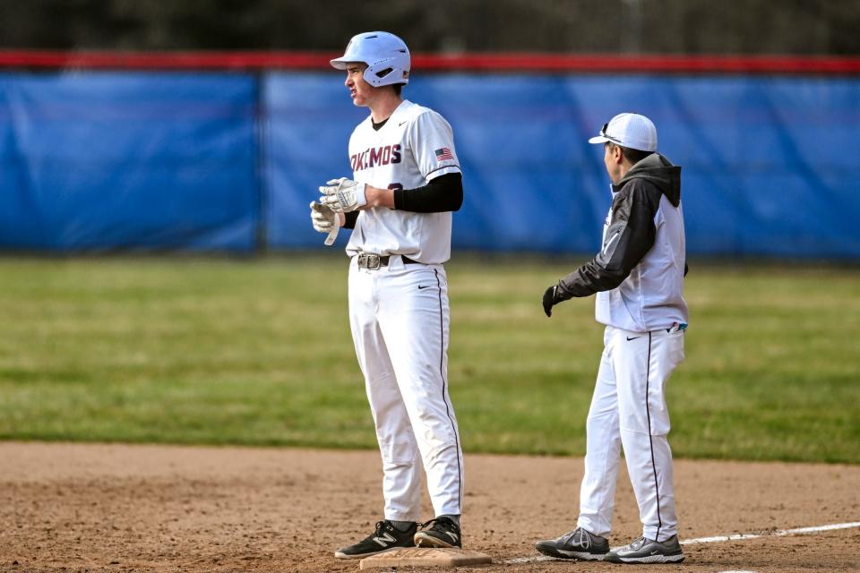 Mason's Colin Walton gets a hit against Okemos during the seventh inning on Friday, April 5, 2024, at Mason High School.