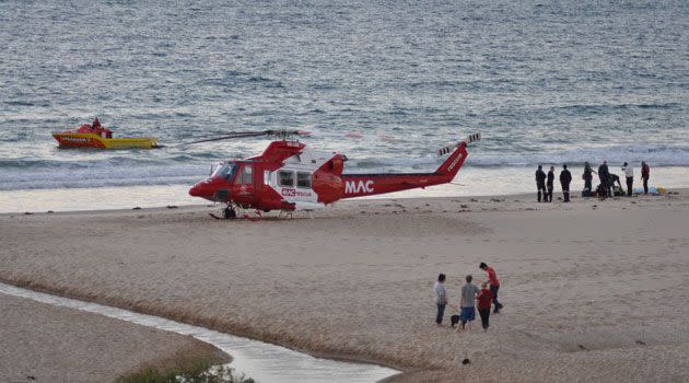 Emergency crews on the beach following the drowning of the man and rescue of his son-in-law. Photo: Andrew Ward.