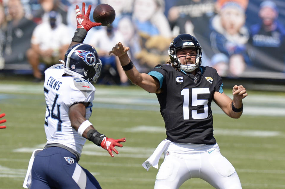 Jacksonville Jaguars quarterback Gardner Minshew (15) passes as he is pressured by Tennessee Titans inside linebacker Rashaan Evans (54) in the first half of an NFL football game Sunday, Sept. 20, 2020, in Nashville, Tenn. (AP Photo/Mark Zaleski)