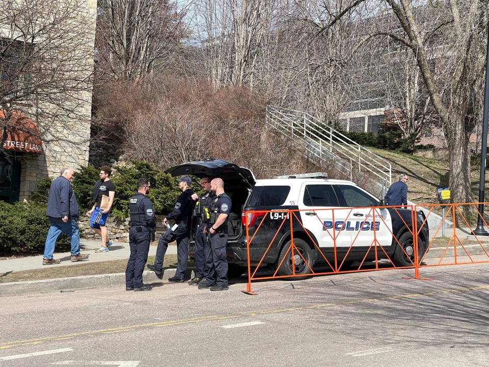 Burlington Police stood outside their cars on College Street by Waterfront Park Monday, April 8, 2024. The department was working full-time to manage the crowds on the day of the total solar eclipse.