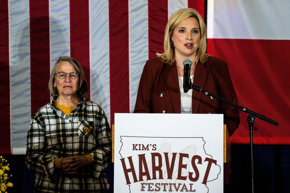 Rep. Ashley Hinson, right, speaks during Gov. Kim Reynolds Harvest Festival at the Elwell Family Food Center at the Iowa State Fairgrounds on Saturday, October 14, 2023 in Des Moines.