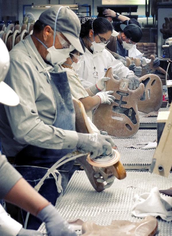 Fender Stratocaster electric guitar bodies are sanded at the Fender factory in Corona, Calif. on Tuesday, Oct. 15, 2013. The iconic instrument, used by countless professional and amateur musicians, celebrates its 60th anniversary in 2014. (AP Photo/Matt York)