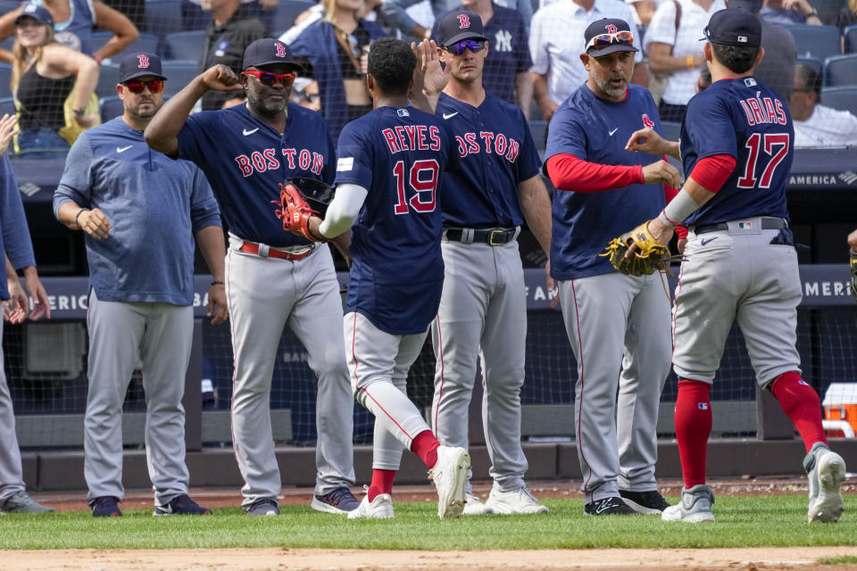 Boston Red Sox manager Alex Cora, second from right, celebrates with Luis Urias (17) and Pablo Reyes (19) after the Red Sox's defeated the New York Yankees in a baseball game, Saturday, Aug. 19, 2023, in New York. The Red Sox won 8-1. (AP Photo/Mary Altaffer)