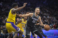 Sacramento Kings forward Domantas Sabonis (10) is defended by Los Angeles Lakers center Thomas Bryant (31) during the first quarter of an NBA basketball game in Sacramento, Calif., Wednesday, Dec. 21, 2022. (AP Photo/José Luis Villegas)