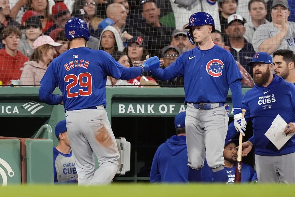 Chicago Cubs' Michael Busch (29) celebrates after scoring on a single by Matt Mervis during the seventh inning of a baseball game against the Boston Red Sox, Sunday, April 28, 2024, in Boston. (AP Photo/Michael Dwyer)