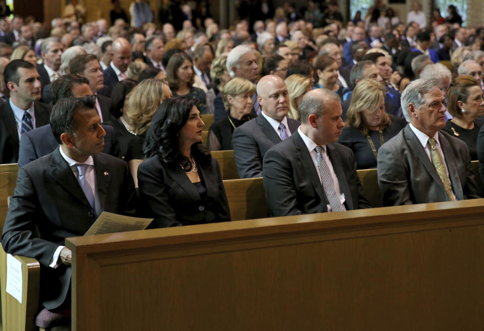 From the left, former Louisiana Governor Bobby Jindal and his wife Supriya, former New Orleans Mayor Mitch Landrieu, and New Orleans Saints general manager Mickey Loomis listen during a Celebration of Life Interfaith Service for former Louisiana Gov. Kathleen Babineaux Blanco, at St. Joseph Cathedral in Baton Rouge, La., Thursday, Aug. 22, 2019. Thursday was the first of three days of public events to honor Blanco, the state's first female governor who died after a years long struggle with cancer.(AP Photo/Michael Democker, Pool)