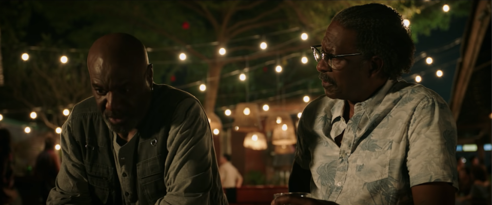 two of the veterans discuss the war at an outdoor bar