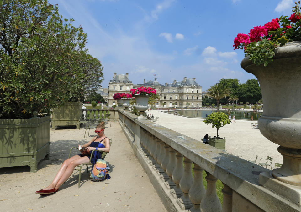 A women sunbathes in the Luxembourg gardens, Wednesday, July 17, 2013. The Luxembourg and Tuileries gardens are Paris' most famous, but the city is also edged by two woods: Vincennes in the east and Boulogne in the west. (AP Photo/Jacques Brinon)