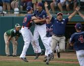 Endwell, N.Y.'s Ryan Harlost, center, begins to celebrate with teammate Jack Hopko, left, after getting the final out of the Little League World Series Championship baseball game against South Korea in South Williamsport, Pa., Sunday, Aug. 28, 2016. New York won 2-1. (AP Photo/Gene J. Puskar)