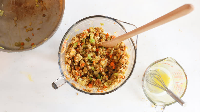 stuffing mix in measuring cup with wooden spoon