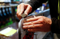 Heinz Haemmerle, or "Magic Heinzi" as US skier Lindsey Vonn calls her Austrian-born ski technician, sharpens the edges on a pair of skis of the world's most successful skiing women in his tiny waxing container at the Winter Olympics 2018 in Pyeongchang, South Korea February 19, 2018. Picture taken February 19, 2018. REUTERS/Leonhard Foeger