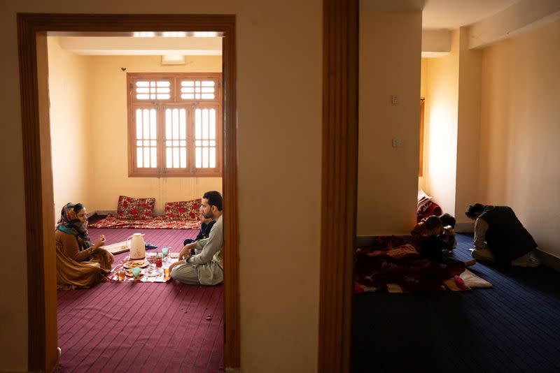 Afghan prosecutor S.M and her family eats lunch in their rented flat, in Peshawar