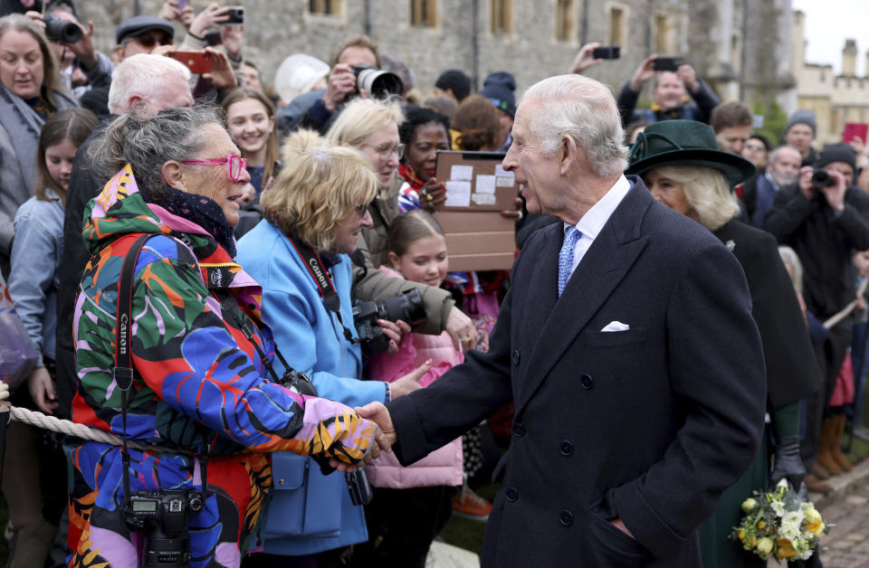 Britain's King Charles III and Queen Camilla greet people after attending the Easter Matins Service at St. George's Chapel, Windsor Castle, England, Sunday, March 31, 2024. (Hollie Adams/Pool Photo via AP)