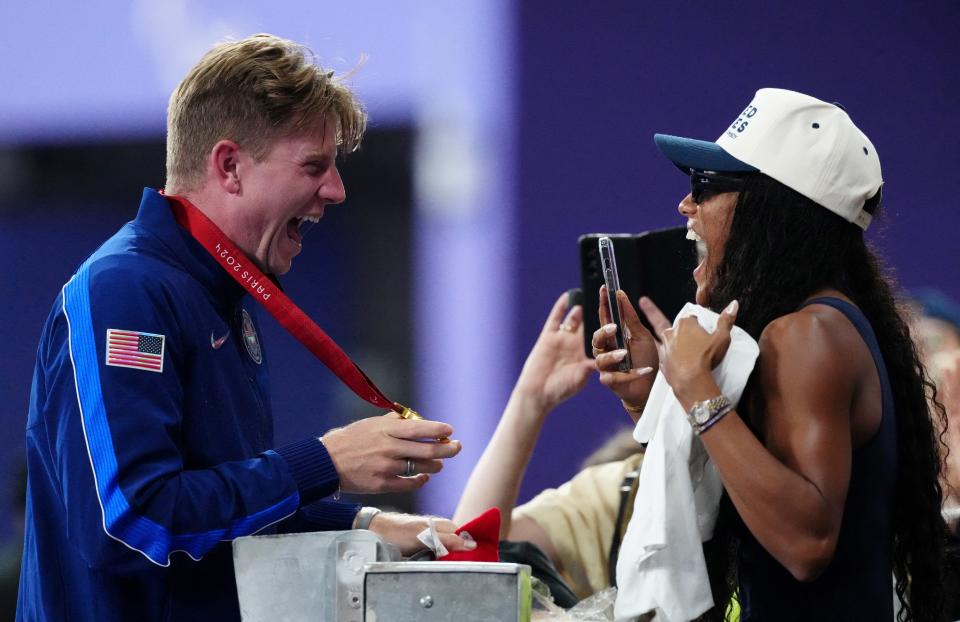 Gold medallist US' Hunter Woodhall (L) celebrates with his wife Olympic women's long jump champion Tara Davis-Woodhall after the victory ceremony for the Men's 400m T62 final event at the Stade de France in Saint-Denis, outside Paris on September 6, 2024. (Photo by Dimitar DILKOFF / AFP) (Photo by DIMITAR DILKOFF/AFP via Getty Images)