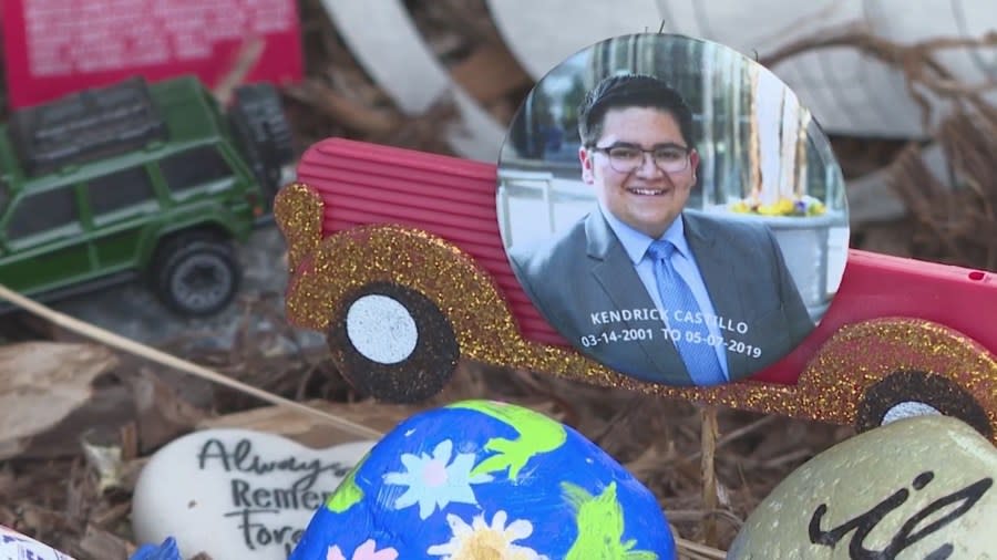 A close-up of a picture of Kendrick Castillo and other items at the foot of a memorial site