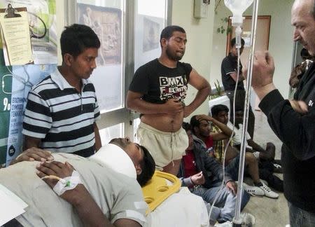 Bangladeshi workers receive first aid at the Medical Center of Varda near the southwestern Greek town of Manolada April 17, 2013, following a shooting incident. Greek police were hunting three foremen on Thursday who were suspected of shooting and wounding more than 20 migrant workers at a strawberry farm. REUTERS/Eurokinissi