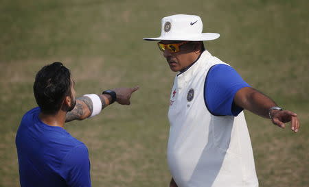 Virat Kohli talks to his team director Ravi Shastri (R) during a practice session ahead of their first test cricket match against South Africa, in Mohali, November 4, 2015. REUTERS/Adnan Abidi