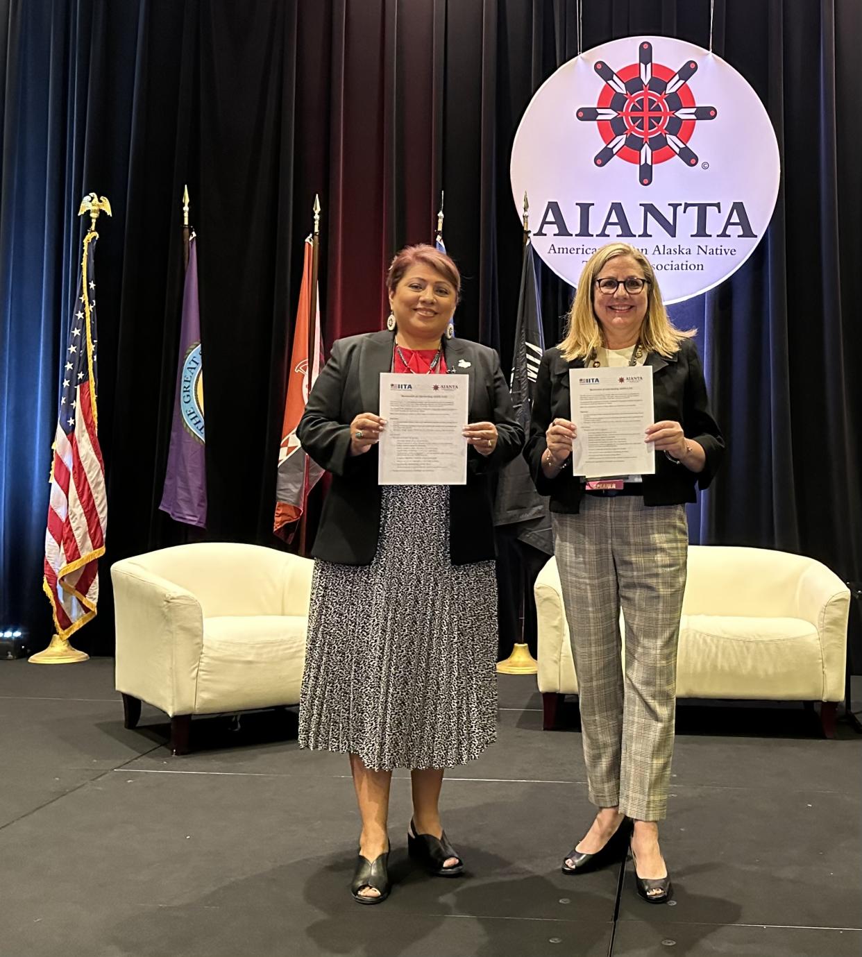 AIANTA // Caption: AIANTA CEO Sherry L. Rupert (left) and IITA CEO & Executive Director Lisa Simon sign the MOU at the 25th Annual American Indigenous Tourism Conference. (Photo/Courtesy of AIANTA)