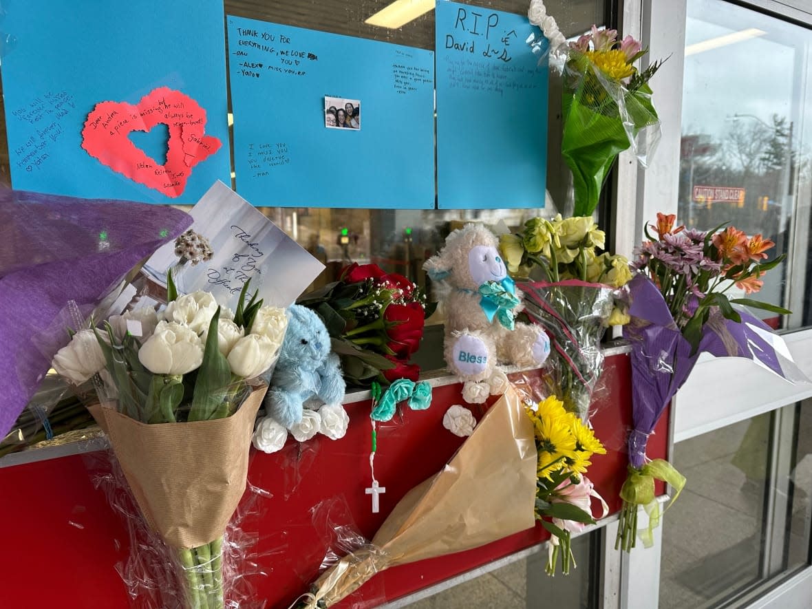 A small memorial next to the entrance of Keele subway station left by friends of Gabriel Magalhaes, 16, who was fatally stabbed inside the station over the weekend. (Meagan Fitzpatrick/CBC - image credit)