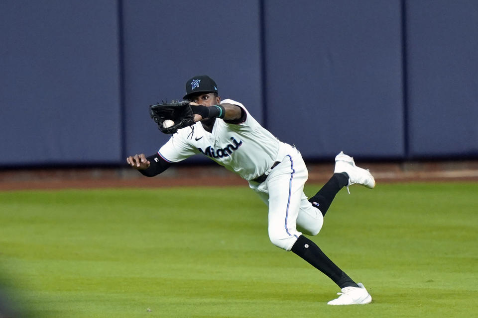 Miami Marlins center fielder Lewis Brinson (25) makes a running catch for the third out on a ball hit by Atlanta Braves' Travis d'Arnaud in the eighth inning in Game 3 of a baseball National League Division Series, Thursday, Oct. 8, 2020, in Houston. (AP Photo/David J. Phillip)