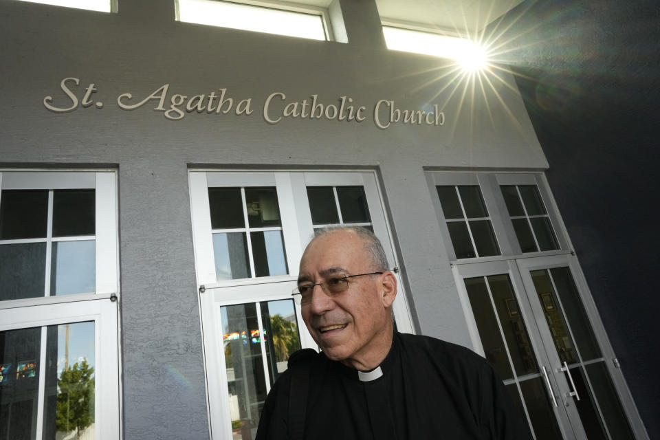 The Rev. Edwing Roman stands outside St. Agatha Catholic Church, which has become the spiritual home of the growing Nicaraguan diaspora, Sunday, Nov. 5, 2023, in Miami. For Father Roman, as well as the auxiliary bishop of Managua, and many in the pews who have had to flee or were exiled from Nicaragua recently, the Sunday afternoon Mass at the Miami parish is not only a way to find solace in community, but also to keep pushing back against the Ortega regime's violent suppression of all critics, including many Catholic leaders. (AP Photo/Rebecca Blackwell)