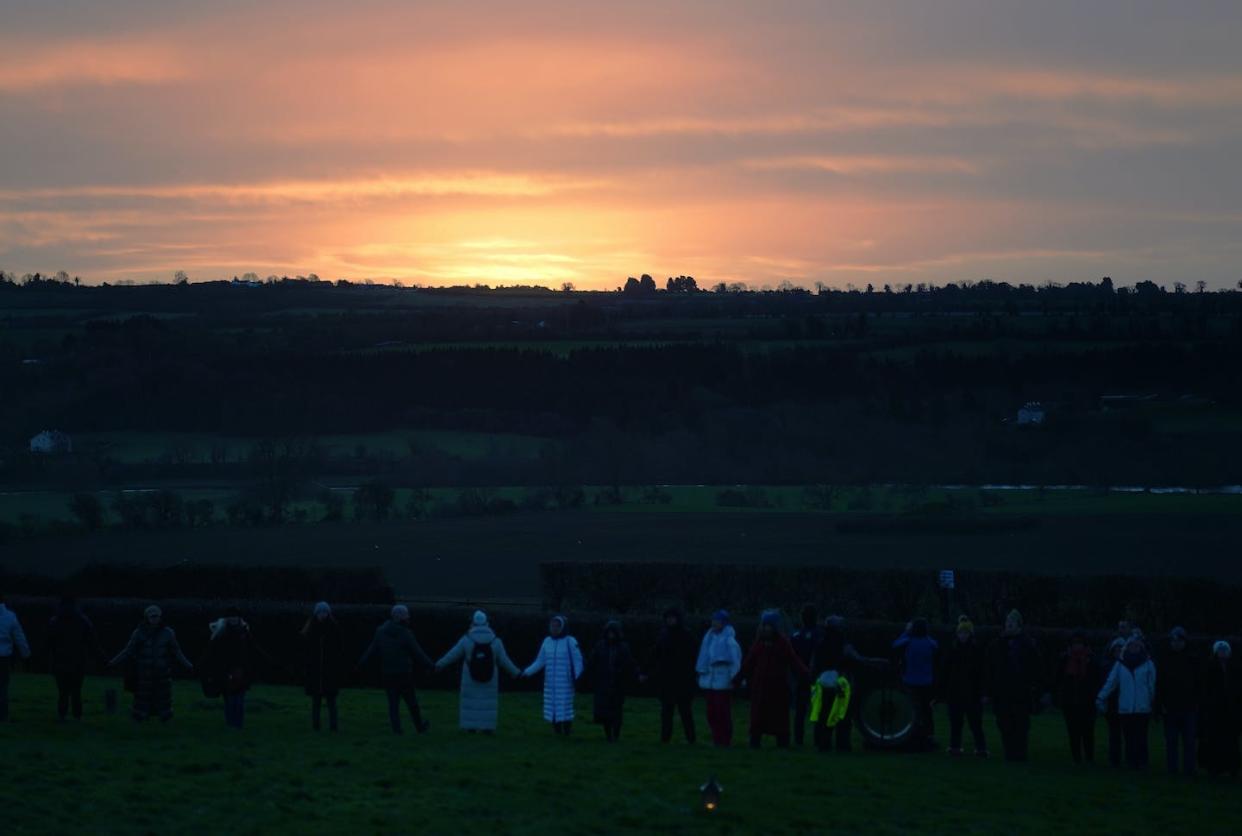 People gather for Pagan sunrise celebrations in Ireland, on the morning of the winter solstice. <a href="https://www.gettyimages.com/detail/news-photo/people-gather-for-sunrise-at-newgrange-co-meath-on-the-news-photo/1245764534?adppopup=true" rel="nofollow noopener" target="_blank" data-ylk="slk:Brian Lawless/PA Images via Getty Images;elm:context_link;itc:0;sec:content-canvas" class="link ">Brian Lawless/PA Images via Getty Images</a>