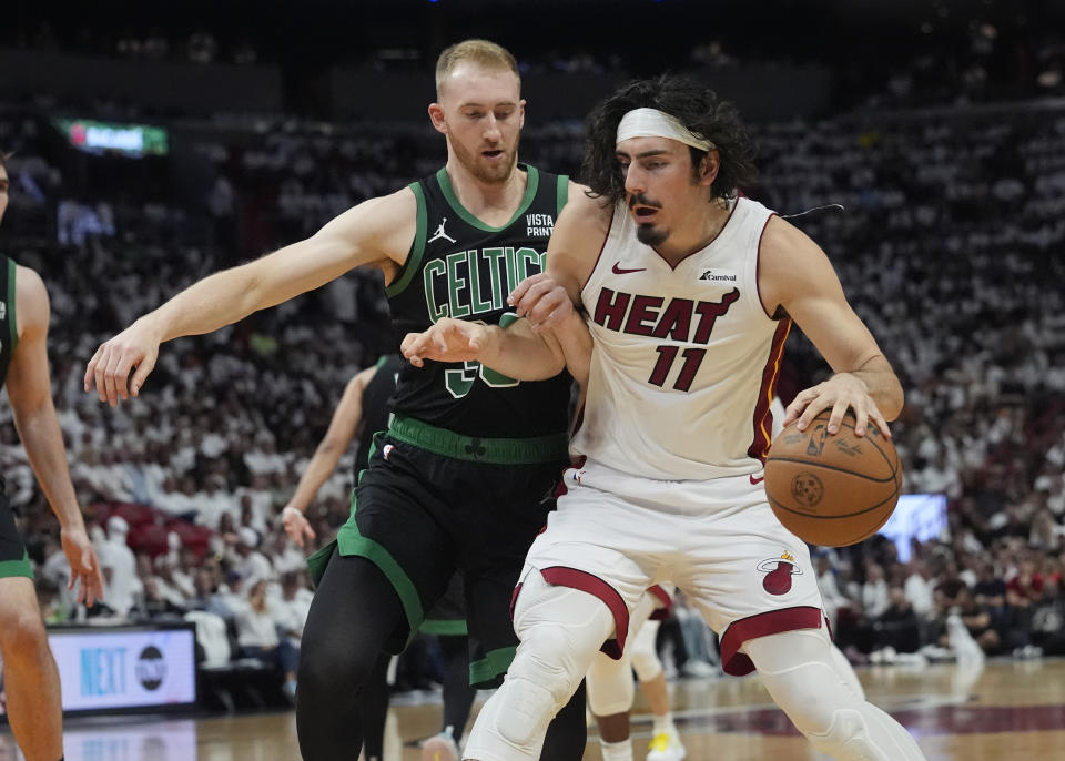 Boston Celtics forward Sam Hauser (30) defends Miami Heat guard Jaime Jaquez Jr. (11) during the second half of Game 4 of an NBA basketball first-round playoff series, Monday, April 29, 2024, in Miami. (AP Photo/Marta Lavandier)