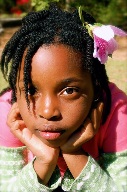 This 2009 photo released by author and blogger Denene Millner shows her daughter, Lila Chiles, 7, in Snellville, Ga. Millner chose to wear her hair natural nearly 14 years ago for the sake of her daughters. "I didn't want them to grow up with the same idea that I had when I was little, that there was something wrong with the way that my hair grew out of my head." (AP Photo/Denene Millner)