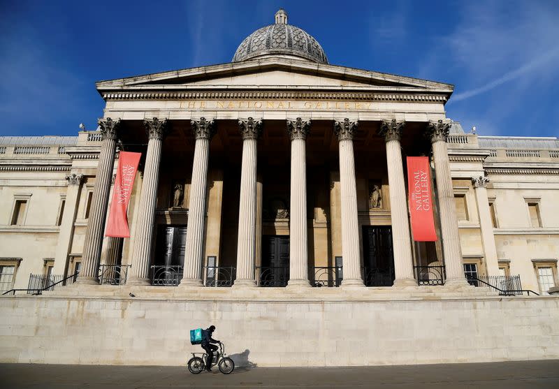 FILE PHOTO: Deliveroo rider cycles past the closed National Gallery in London