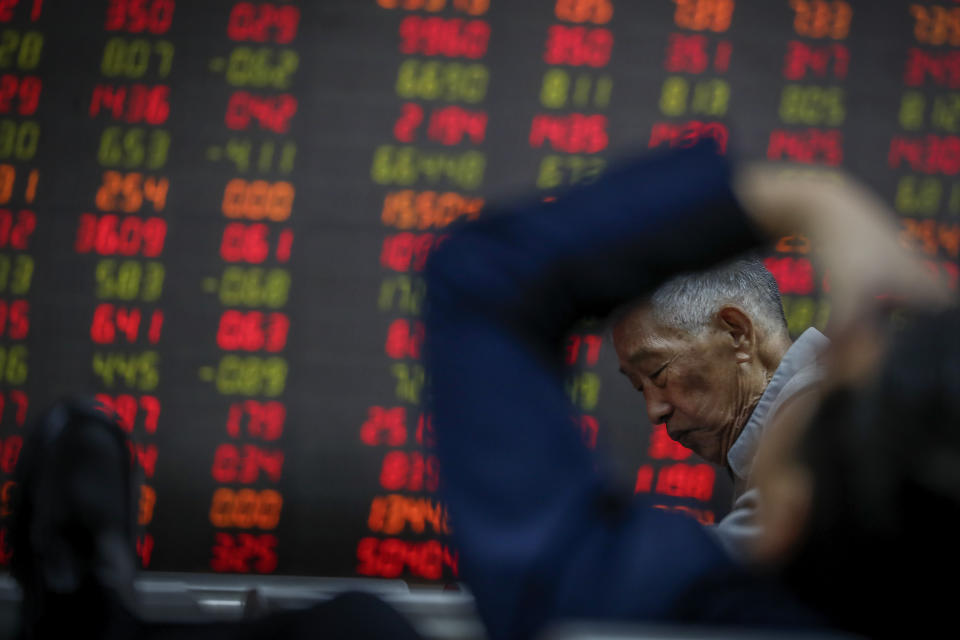 Chinese investors react as they monitor stock prices at a brokerage house in Beijing, Wednesday, Oct. 16, 2019. Asian shares were higher Wednesday after a gain on Wall Street boosted by healthy earnings reports from U.S. companies. (AP Photo/Andy Wong)