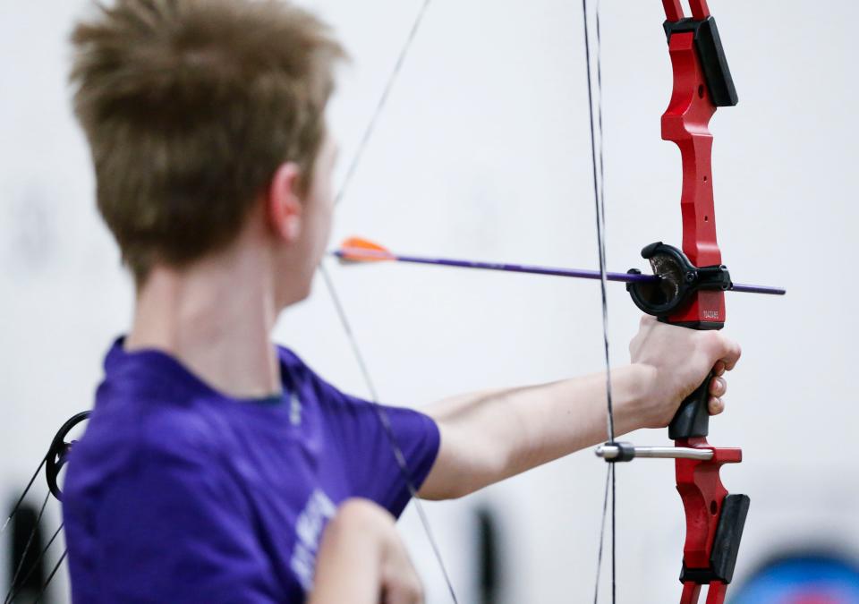 Hickory Hills Middle School seventh grader Toby Hopkins, who has limited mobility on the right side of his body, readies his bow that has been adapted to shoot using his mouth during a state-qualifying tournament at the Ozark Empire Fair Grounds Central Building on Wednesday, Jan. 31, 2024.