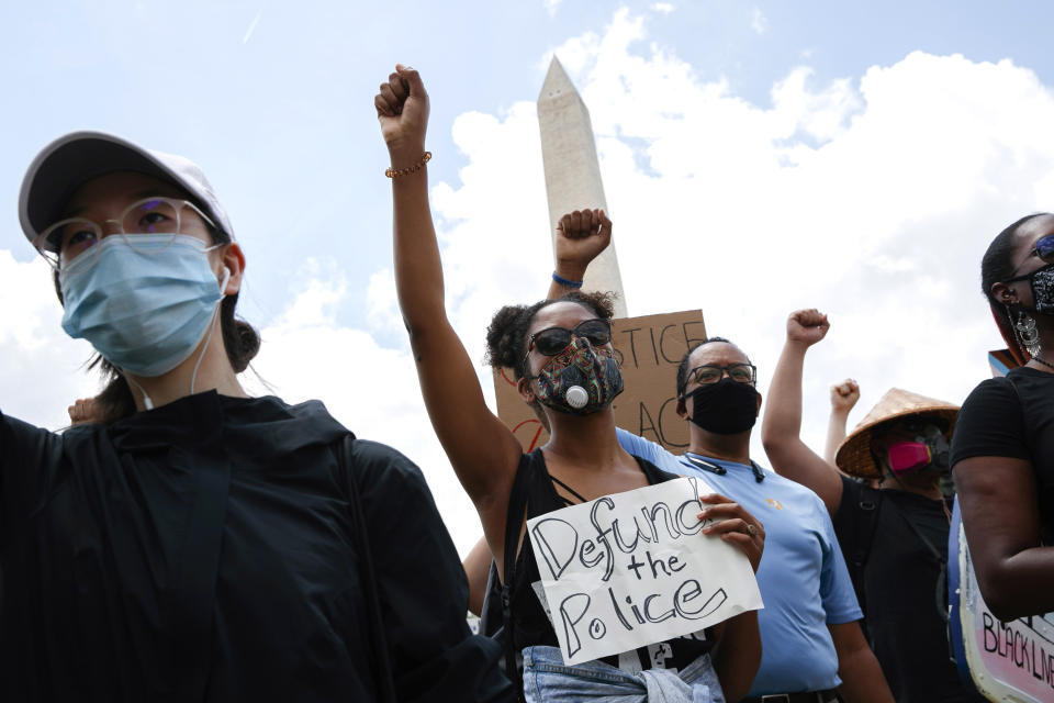 Dalyce Wilson, center, of Silver Spring, Md., joins a march by the Washington Monument as people demonstrate in Washington on Friday, June 19, 2020, to mark Juneteenth, the holiday celebrating the day in 1865 that enslaved Black people in Galveston, Texas, learned they had been freed from bondage, more than two years after the Emancipation Proclamation. (AP Photo/Jacquelyn Martin)